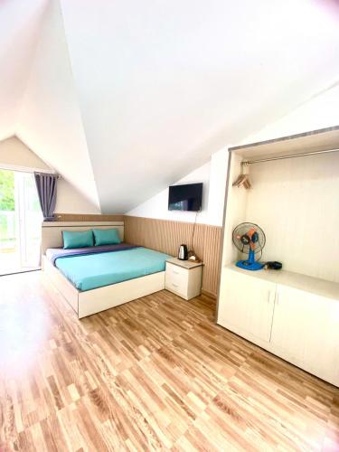 a bedroom with a large bed and a wooden floor at Khách sạn An An Đà Lạt in Da Lat