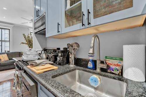 a kitchen with a sink and a counter top at Elegant 3BR-2BA in Gramercy -Modern & Central in New York