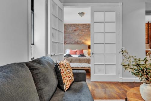 a living room with a couch and a bedroom at Elegant 3BR-2BA in Gramercy -Modern & Central in New York