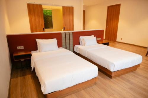 a hotel room with two beds in a room at Haven in the Pines in Ðinh An (2)
