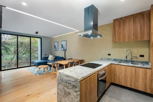 a kitchen and living room with a couch and a table at ZKH Luxury Collection Roma Norte in Mexico City