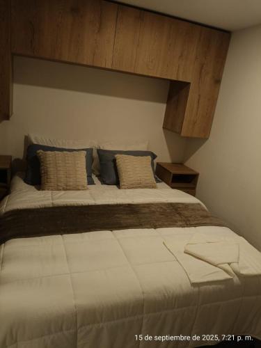 a bedroom with a large bed in a room at Modern studio in a tourist and university area in Bogotá