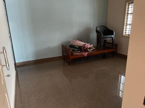 a room with a table and a chair in a room at Nandini home stay in Sringeri