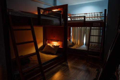 a couple of bunk beds in a room at Phangan Barsay Hostel in Thongsala