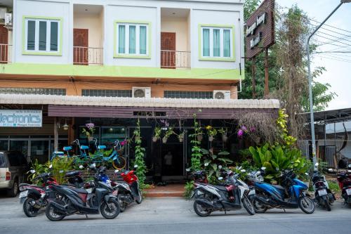 a group of motorcycles parked in front of a building at Phangan Barsay Hostel in Thongsala