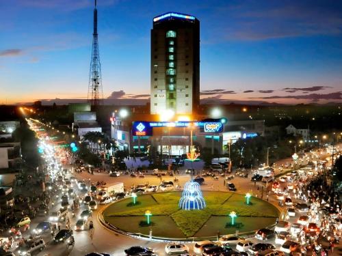 a city at night with a building and a fountain at BMC Ha Tinh hotel in Ha Tinh
