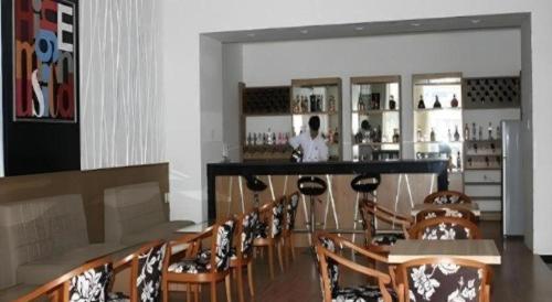 a bar in a restaurant with a bunch of chairs at BMC Ha Tinh hotel in Ha Tinh