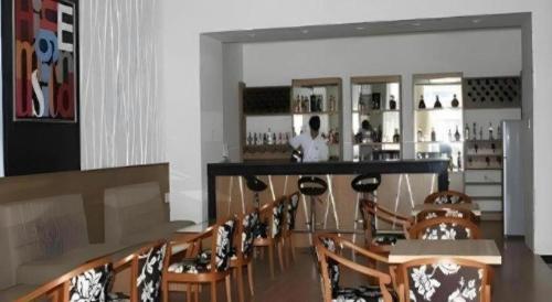 a bar with a bunch of chairs in a room at BMC Ha Tinh hotel in Ha Tinh