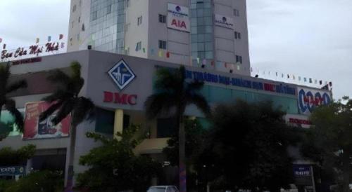 a building with a dmc sign on the side of it at BMC Ha Tinh hotel in Ha Tinh