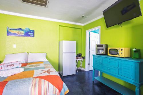 a bedroom with a bed and a tv on a wall at The Mermaid on the Cotee River in Port Richey
