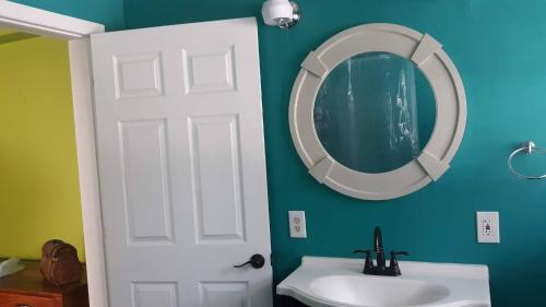 a bathroom with a white sink and a mirror at The Mermaid on the Cotee River in Port Richey