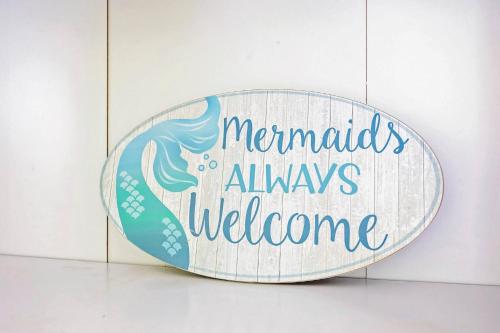 a sign that says mermaids always welcome at The Mermaid on the Cotee River in Port Richey