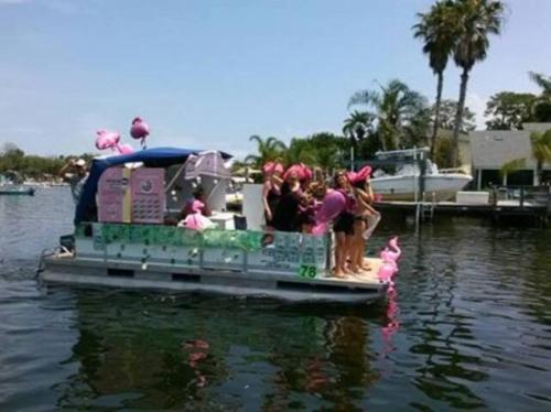 a group of people standing on a boat in the water at The Mermaid on the Cotee River in Port Richey