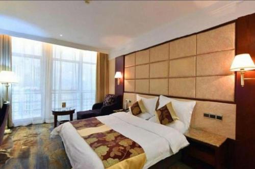 a hotel room with a large bed and a large window at Fuzhou Fuqing Ruixin Hotel in Fuzhou
