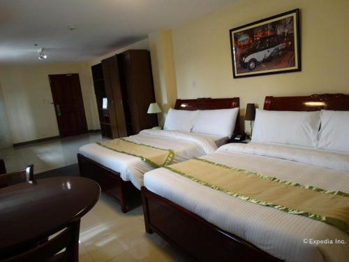 Ένα ή περισσότερα κρεβάτια σε δωμάτιο στο Time Travellers Hotel