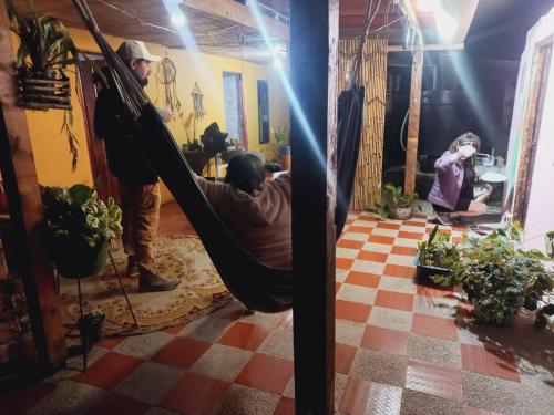 a man laying on a hammock in a room at Mahatma Experiencias que Sanan in Filandia