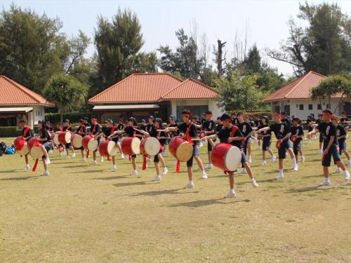 a large group of people dancing in a field at Nature Miraikan in Naha