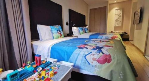 a bedroom with a large bed with toys on it at Yitel Shenyang Sanhao Street Shengjing Hospital in Shenyang