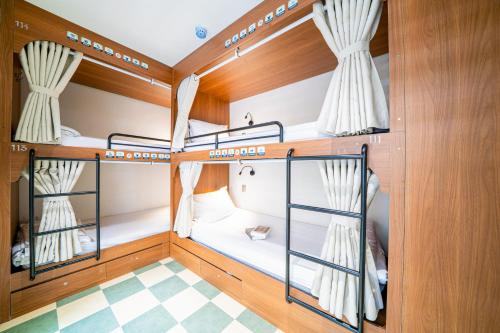 a room with three bunk beds on a boat at Sujet Residence Da Nang by Haviland in Da Nang