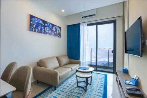 a living room with a couch and a tv at 1001 Nights Hotel, Trademark Collection by Wyndham in Genting Highlands