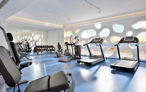 a gym with treadmills and ellipticals in a room at Anax Resort and Spa in Agios Ioannis Mykonos