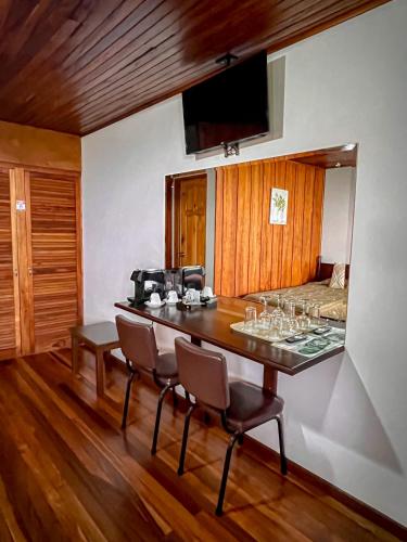 a dining room with a table with wine glasses on it at Hotel Montaña Monteverde in Monteverde Costa Rica