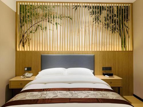 Ένα ή περισσότερα κρεβάτια σε δωμάτιο στο GreenTree Inn Express Fuzhou Minhou County Mindu Custom Park
