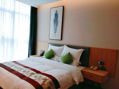 Ένα ή περισσότερα κρεβάτια σε δωμάτιο στο GreenTree Inn Express Fuzhou Minhou County Mindu Custom Park