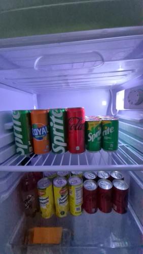 a refrigerator filled with lots of soda cans at Casitas Veyra in Norte
