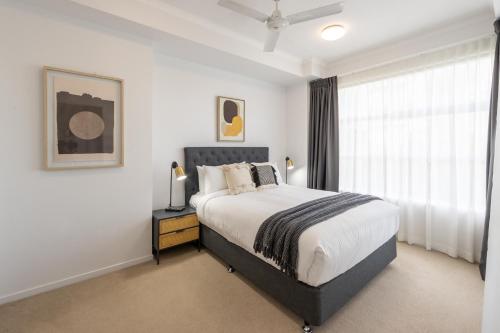 a bedroom with a large bed and a window at Boulevard North Lakes in North Lakes