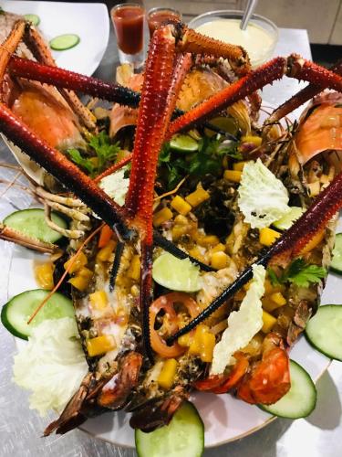 a plate of food with a pile of seafood at Guru Beach Resort in Tangalle