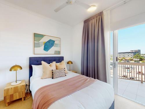 a bedroom with a large bed and a large window at Boulevard North Lakes in North Lakes