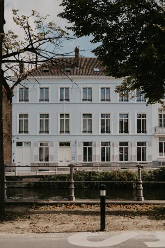 a large white building with a lot of windows at Isidore in Bruges