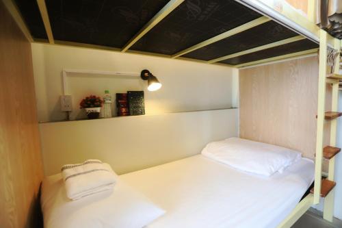 a small room with two bunk beds in it at Hue Imperial Hostel in Hue