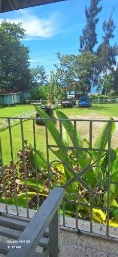 a bench in front of a fence with a park at Casa Mariner Resort in Good Hope