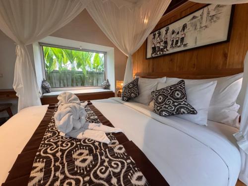 a bedroom with a bed with a stuffed animal on it at Aura by Nature, Absorb the MAGIC Around in Tegalalang