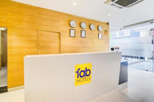 a foto hogs store with clocks on the wall at FabHotel Prime Veeraj Suites- Nr Skyview10, Lumbini Avenue, Gachibowli in Hyderabad