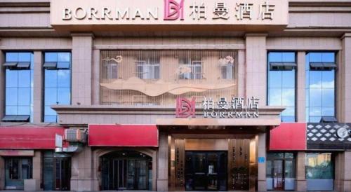 a building with a sign that reads bramannetts at Borrman Hotel Korla Peacock River in Korla