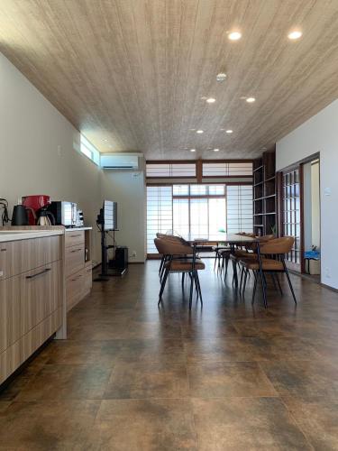 a kitchen and dining room with a table and chairs at DAISEN UMIHOTARU Entire house in Daisen