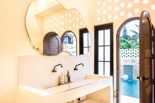 a bathroom with a sink and a mirror at Casa Dapyo in Sampong