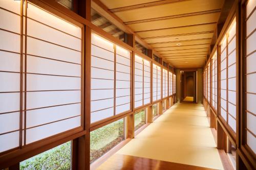an empty hallway with windows in a building at Akazawa Geihinkan in Ito