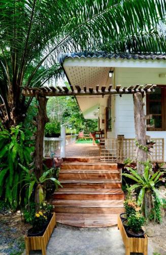 a wooden stairway leading to a house with a woodenvisor at Kood Life in Ko Kood