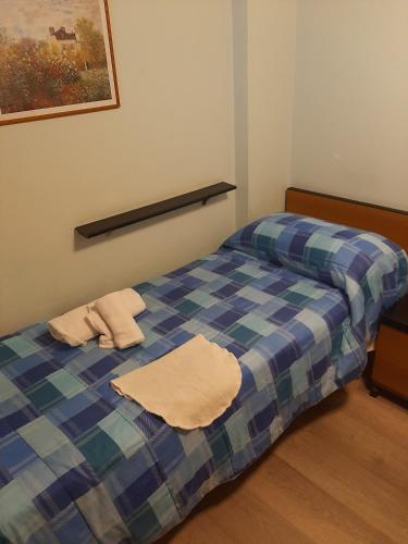 a bed with two towels sitting on top of it at Hotel Niagara Rimini in Rimini