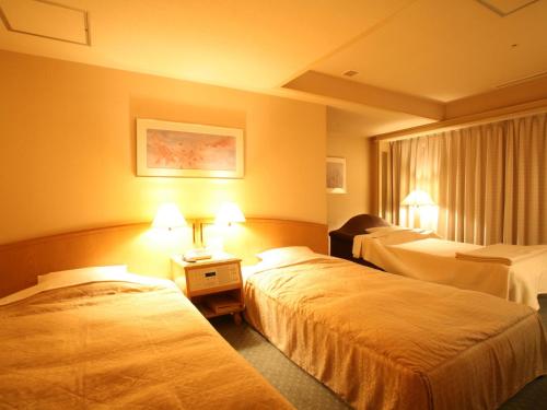 Ένα ή περισσότερα κρεβάτια σε δωμάτιο στο Jasmac Plaza Hotel