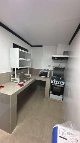 a kitchen with a counter and a stove in it at Windmill Bliss in Pililla