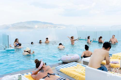 a group of people sitting in a swimming pool at MAISON SEAFRONT RESIDENCE Nha Trang in Nha Trang