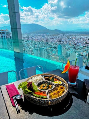 a tray of food on a table with a view at MAISON SEAFRONT RESIDENCE Nha Trang in Nha Trang