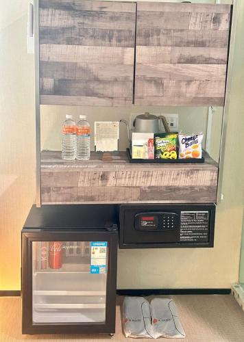 a kitchen with a microwave and a counter top at A Hotel Chinatown- Stay From 8PM To 9AM in Singapore