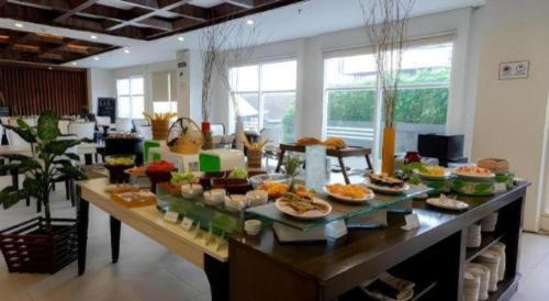 a buffet of food on a table in a room at Java Lotus Hotel Jember in Jember