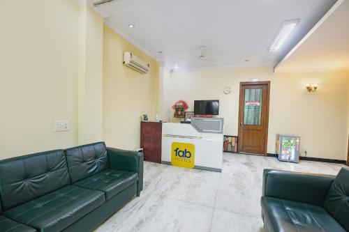 a living room with a couch and a tv at FabHotel The Silken Stay in Gurgaon